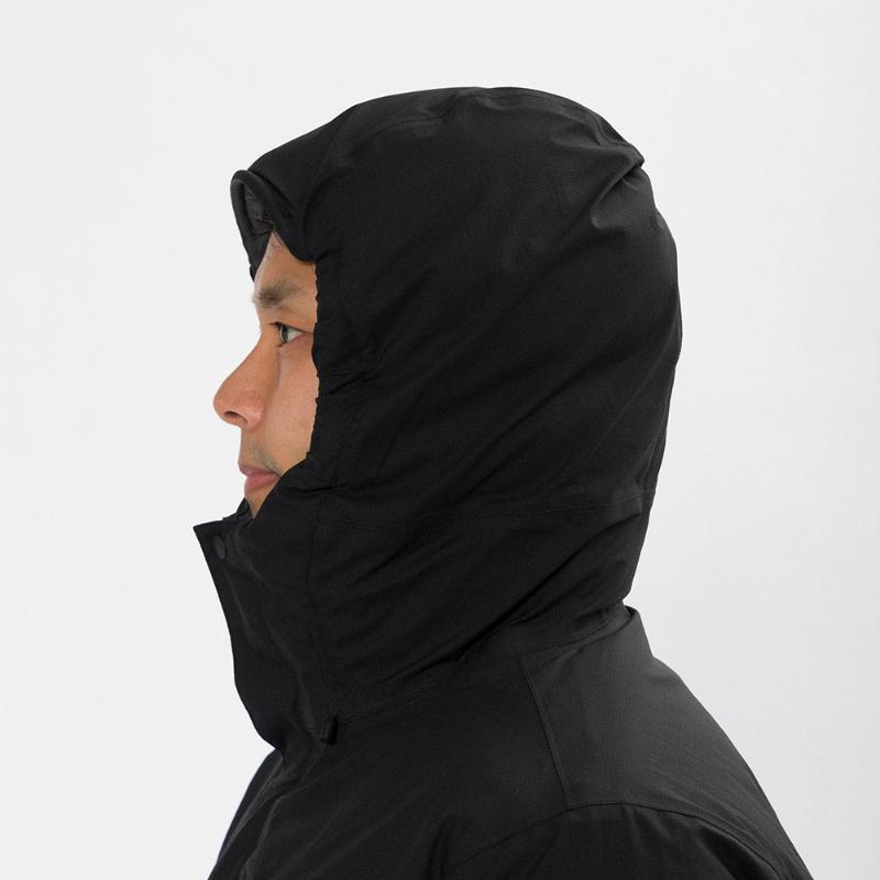 Montbell Men's Aspen Down Half-Length Coat in Black, showcasing its sleek, waterproof urban design.