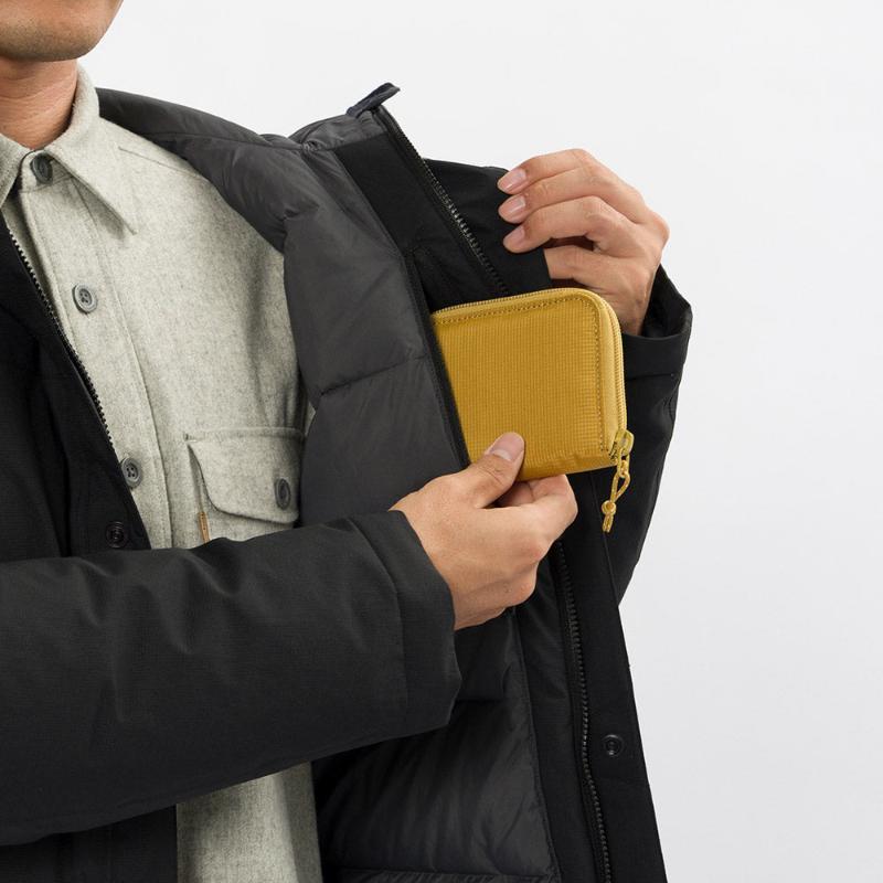 Montbell Men's Aspen Down Half-Length Coat in Black, showcasing its sleek, waterproof urban design.