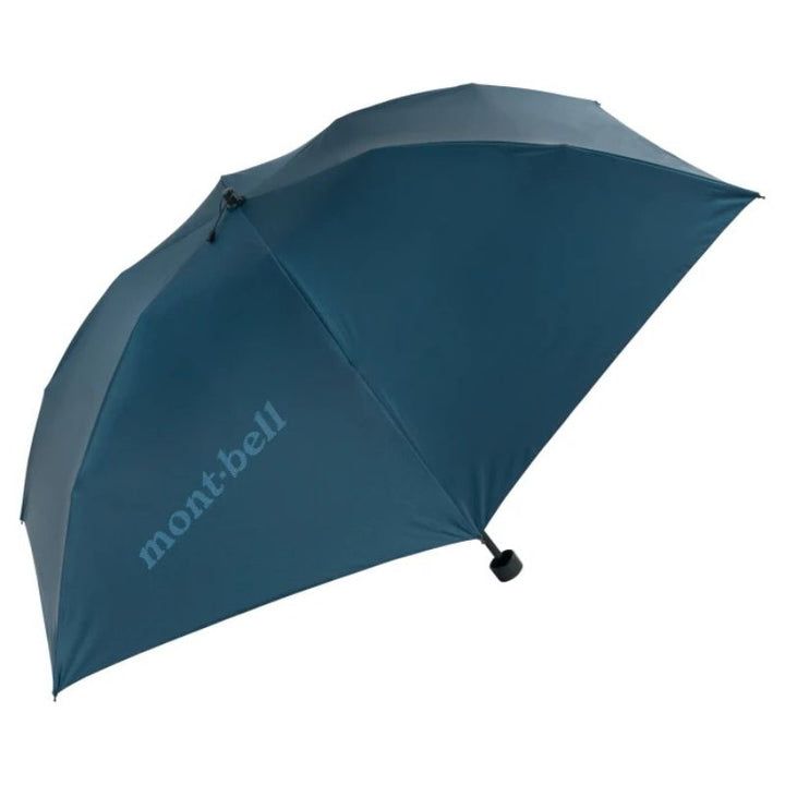A folded BLUE GREEN Montbell umbrella with a compact design, featuring a branded label when opened.