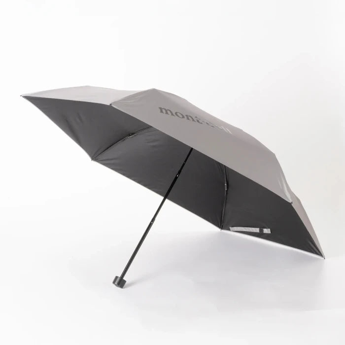 Montbell Travel Sunblock Umbrella 50 in Light Grey, featuring a silver-coated exterior and dark interior.