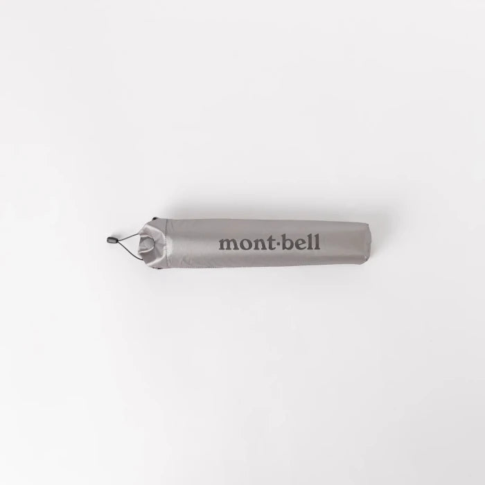 Montbell Travel Sunblock Umbrella 50 in Light Grey, featuring a silver-coated exterior and dark interior.