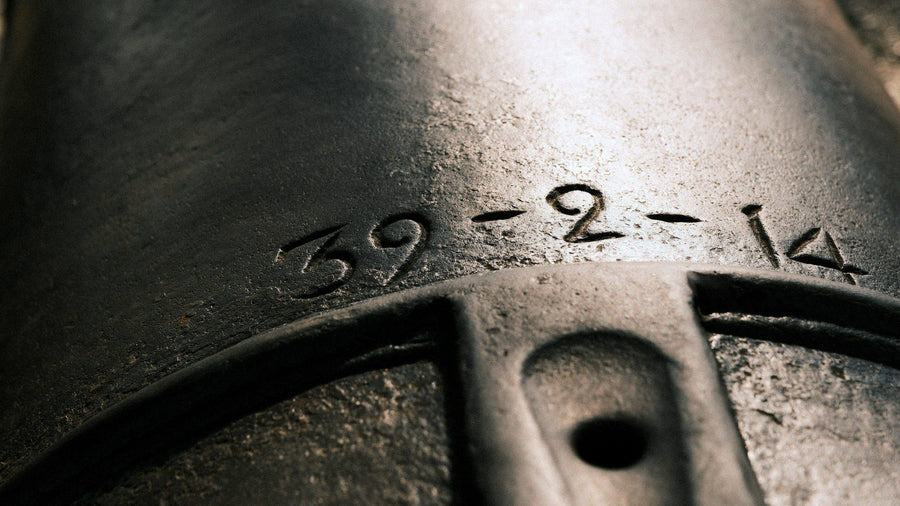 Close-up of engraved numerals on a weathered metal surface