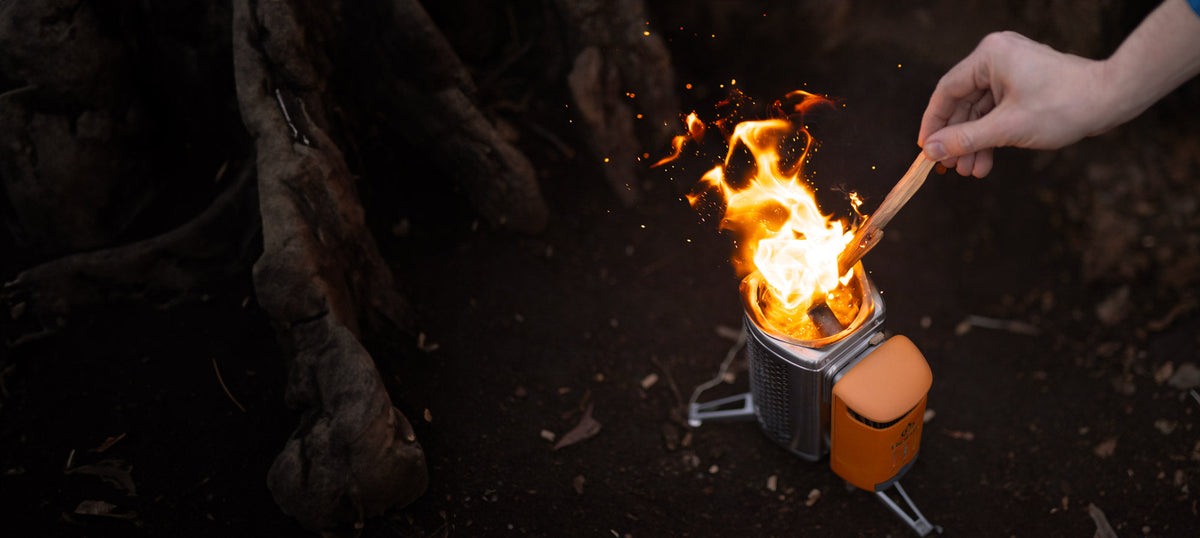 BioLite CampStove 2+ being lit with wood at night