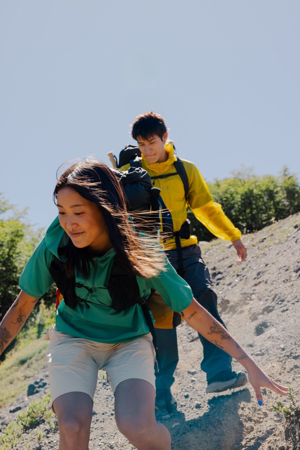 Two hikers on a rocky trail in Kolon Sport gear