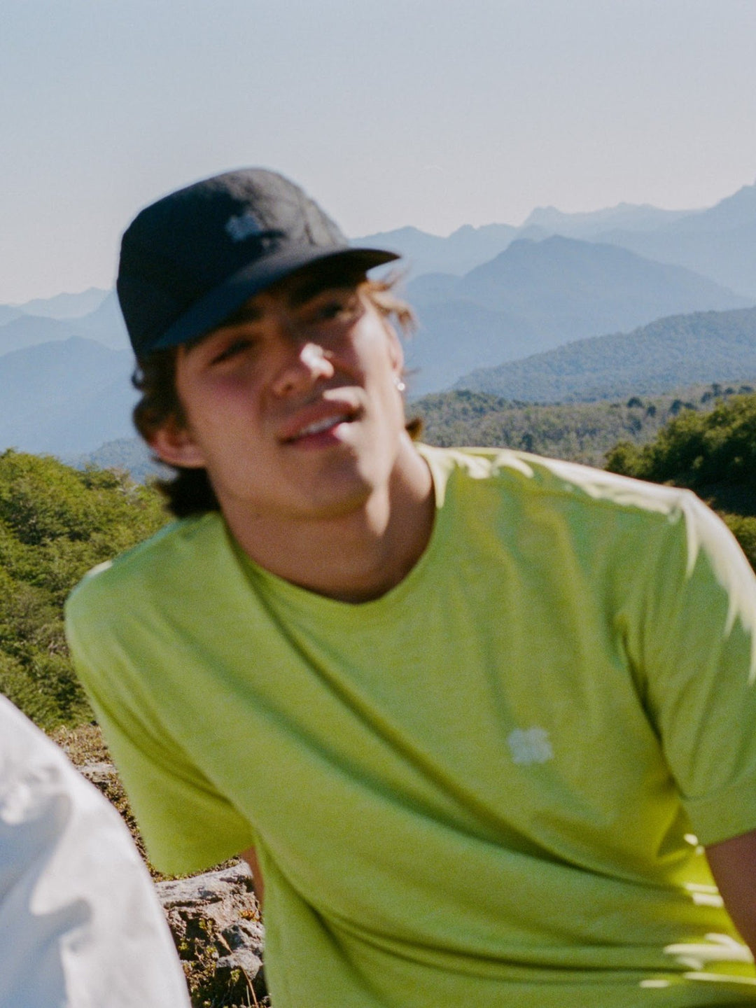 Hiker in a Kolon Sport tee with mountains behind