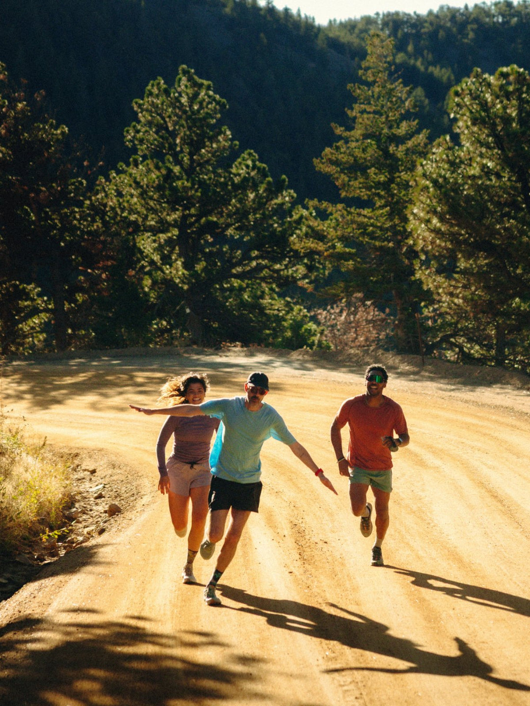 Trail runners on a sandy forest path in Smartwool merino