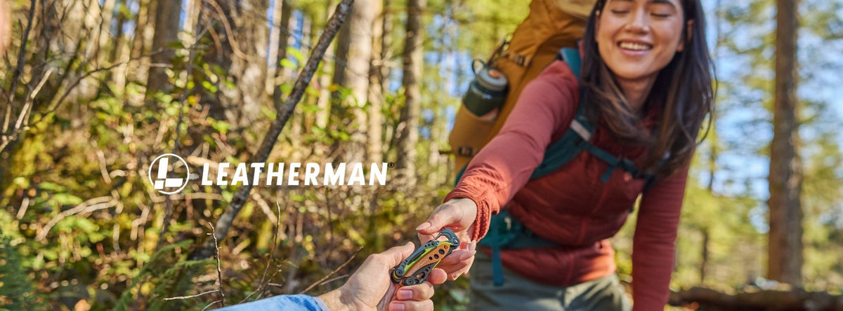 Hiker in a forest handing over a Leatherman multi-tool